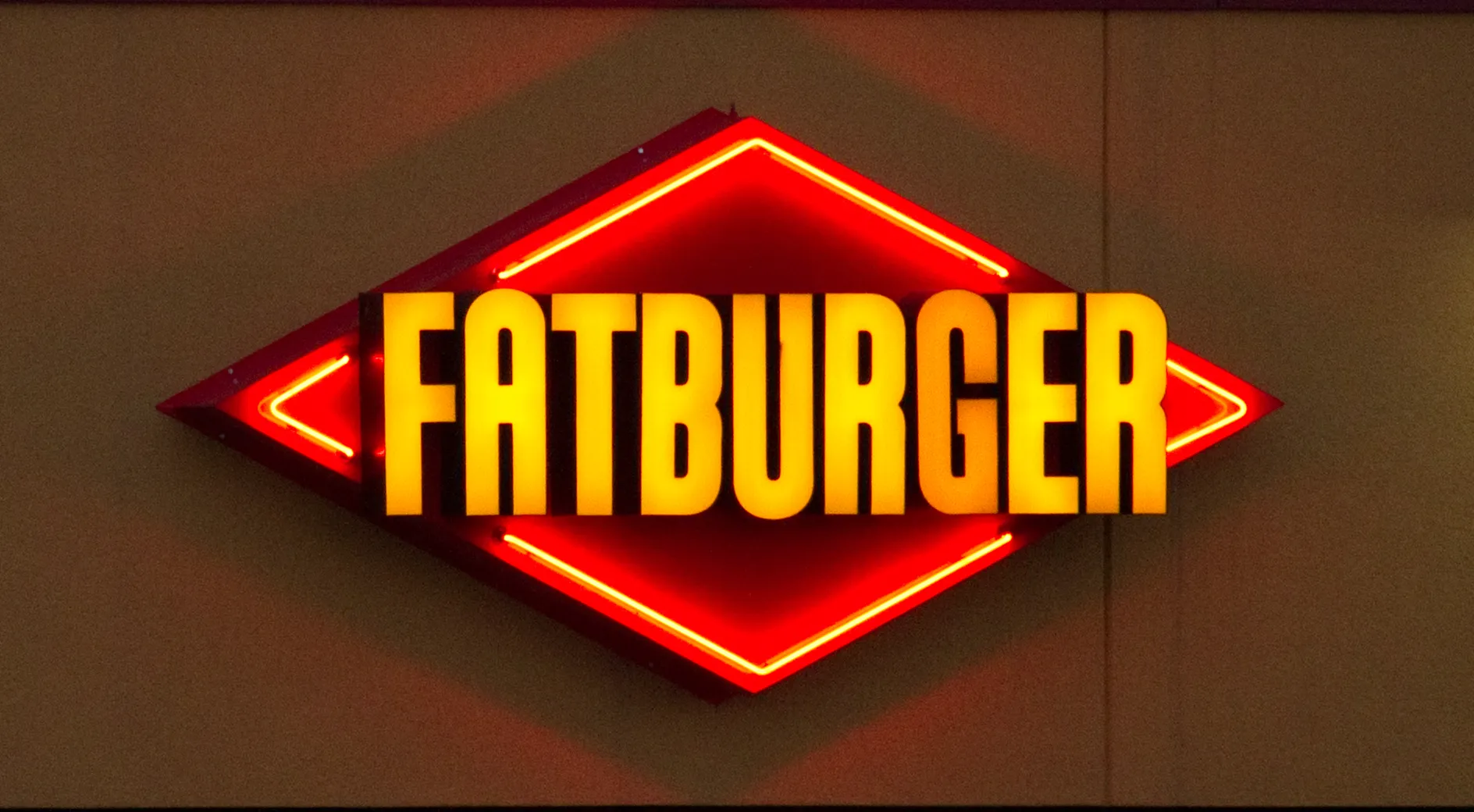 Red and yellow Fatburger neon sign, the logo of the Los Angeles chain behind the Tunisia Mall burger franchise in Tunis