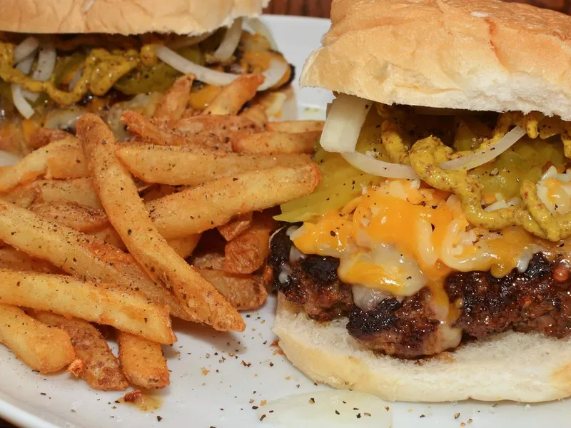 MUNCH'S Burger Shack Tokyo Colby Jack cheeseburger with melted cheese and fries on red-checkered plate