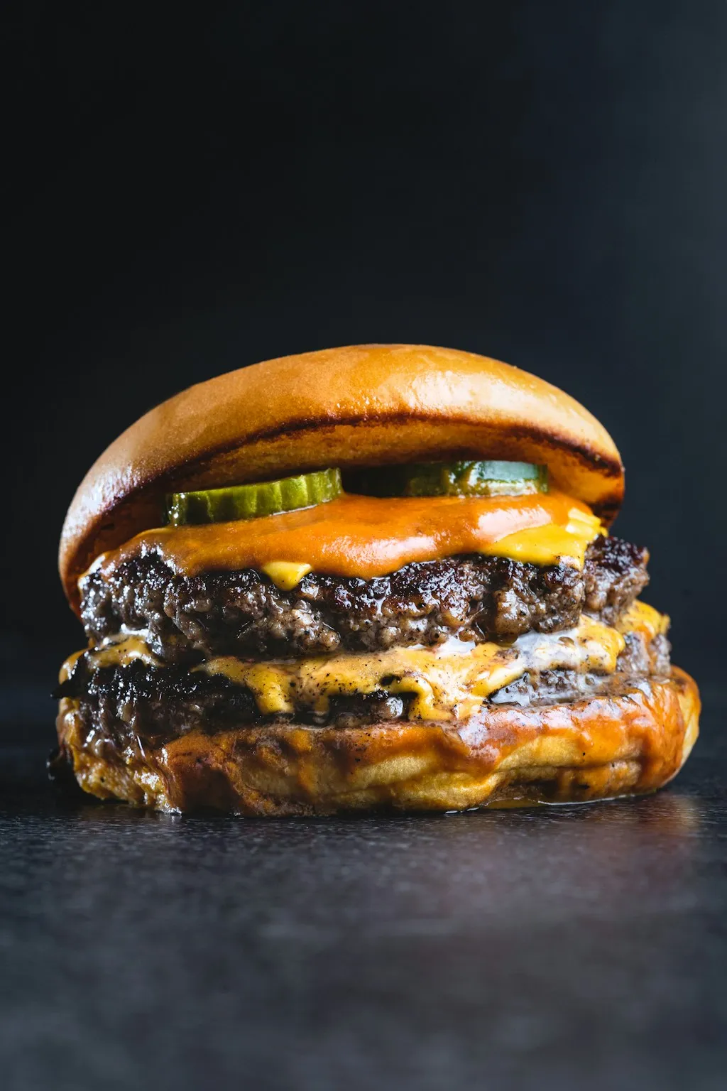 Double smash burger with American cheese, pickles and lacy browned patty edges